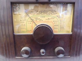 A vintage Ekco Type UAW70 All Electric, bakelite cased radio receiver with a printed dial  20"h