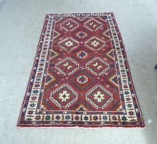 A Kelim rug, decorated with star and diamond design motifs, on a mainly red ground  48" x 77"