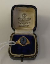 A gentleman's 9ct gold signet ring, set with a carved grey stone tablet