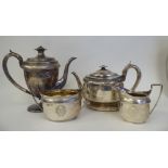 A George III silver five piece tea set of oval form with engraved ornament, including armorials