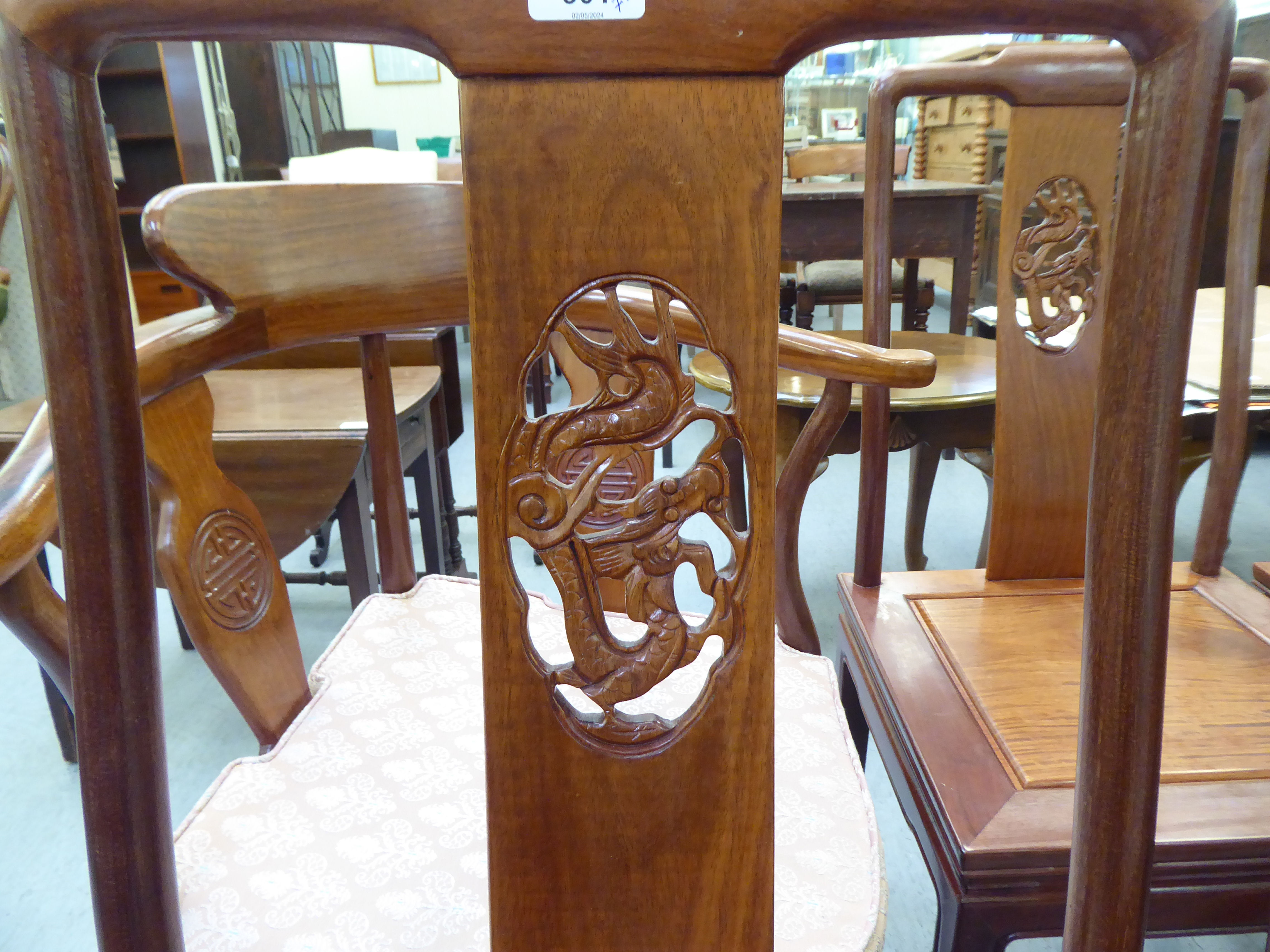 A set of seven modern Chinese, rosewood framed dining chairs, each with a dragon carved splat, - Image 2 of 5