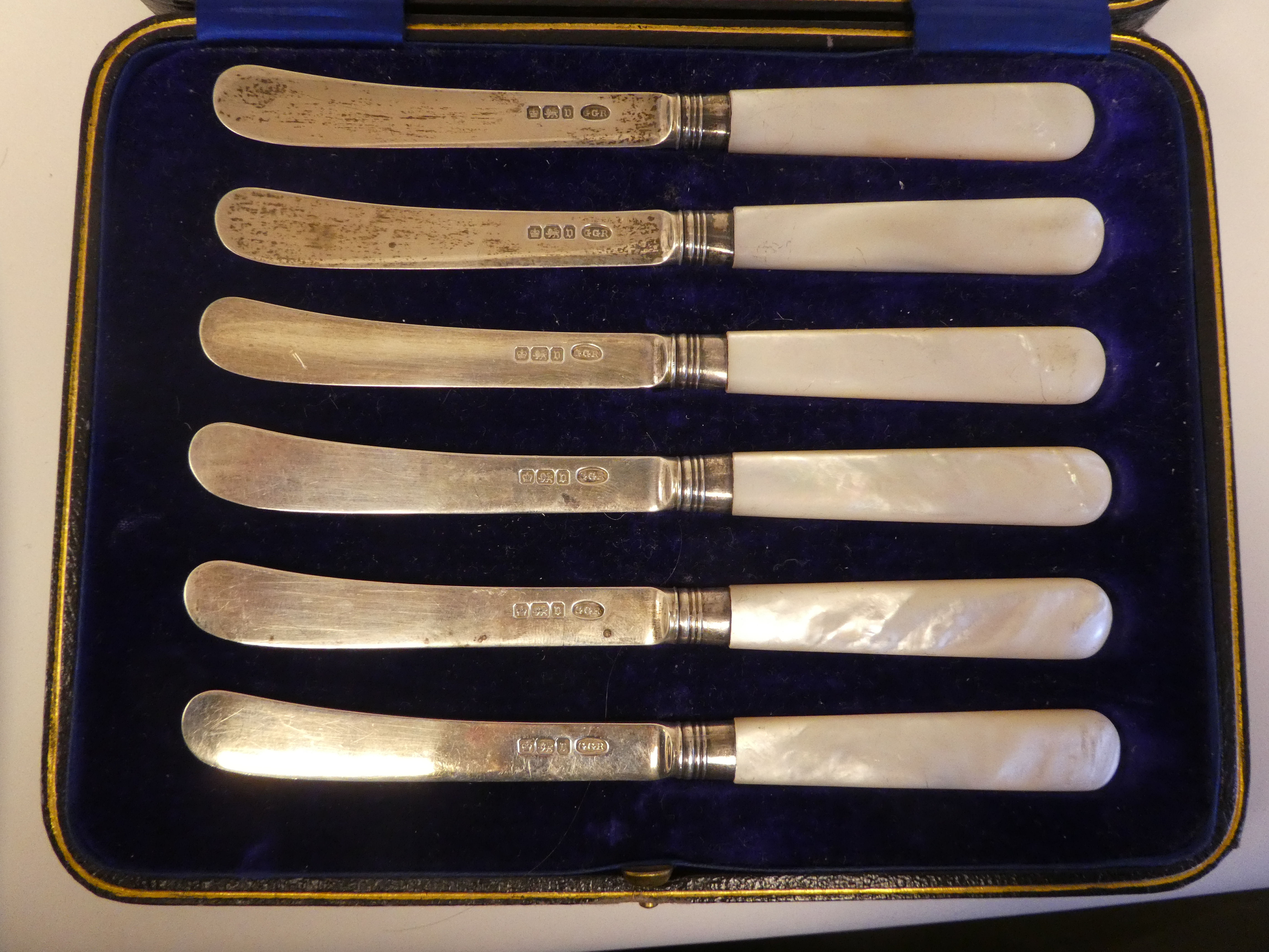 A set of six silver dessert knives, on mother-of-pearl handles  cased; and a matched set of - Image 2 of 7