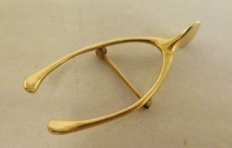 A 14ct gold wishbone design brooch