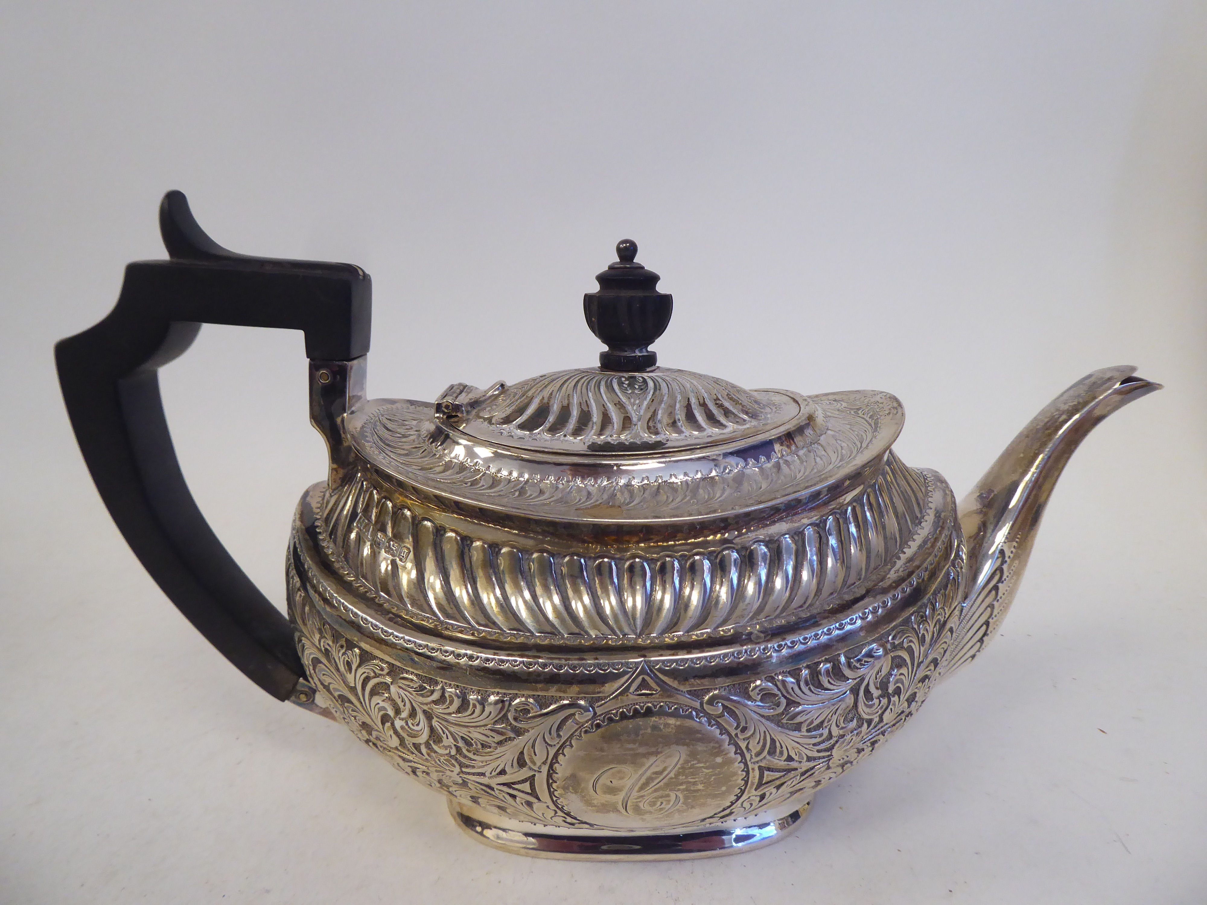 A late Victorian silver three piece tea set of oval form with engraved, chased and demi-reeded - Image 8 of 10