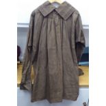 A Continental artisan's brown calico pleated smock with simple decoration to the colour