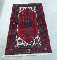A Persian rug, on a red ground  37" x 59"