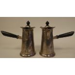 A pair of silver chocolate pots of tapered, cylindrical form with decoratively pierced and flared