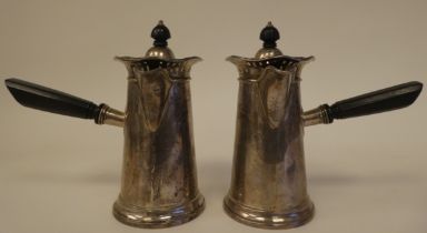 A pair of silver chocolate pots of tapered, cylindrical form with decoratively pierced and flared