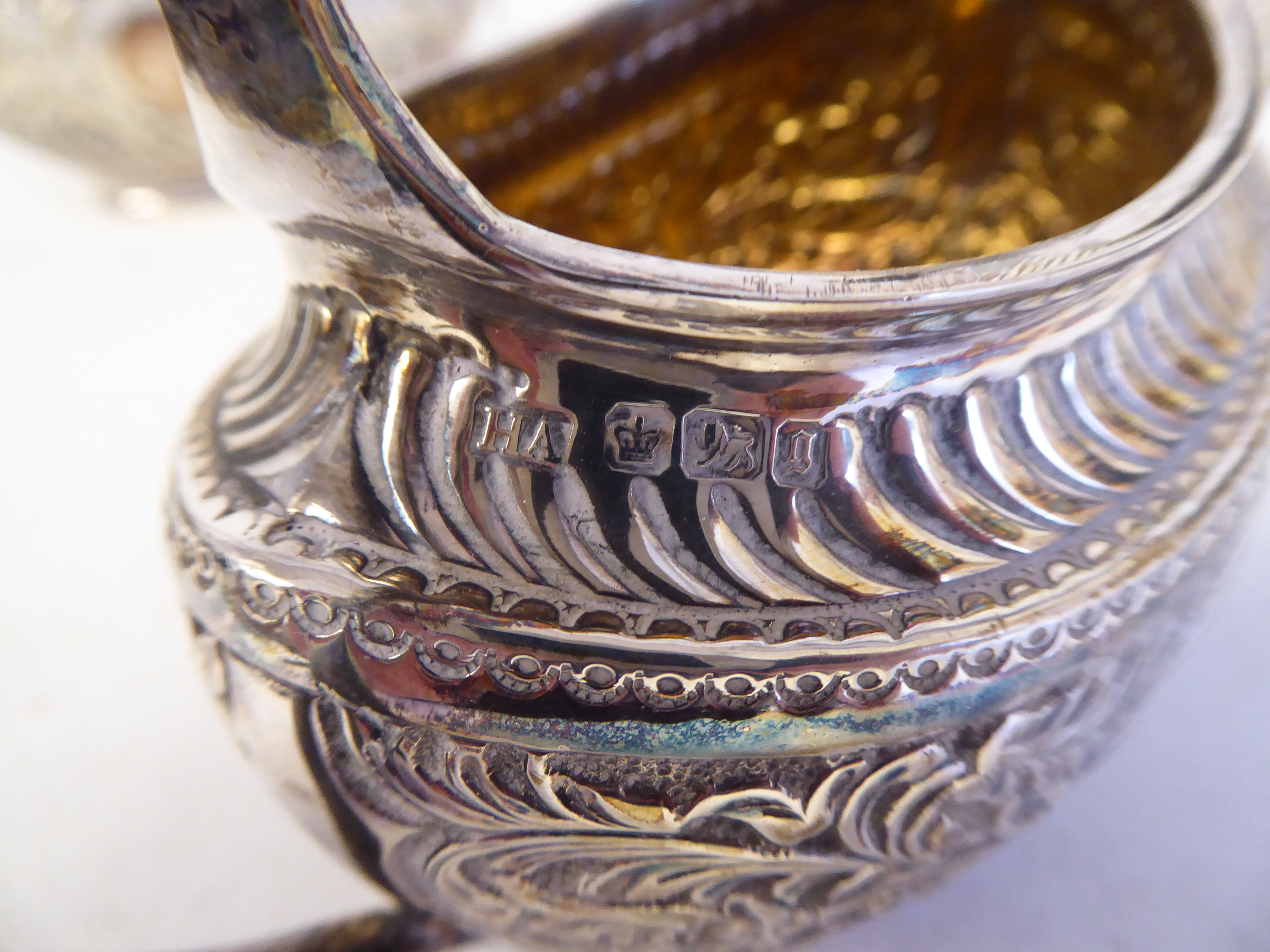 A late Victorian silver three piece tea set of oval form with engraved, chased and demi-reeded - Image 4 of 10