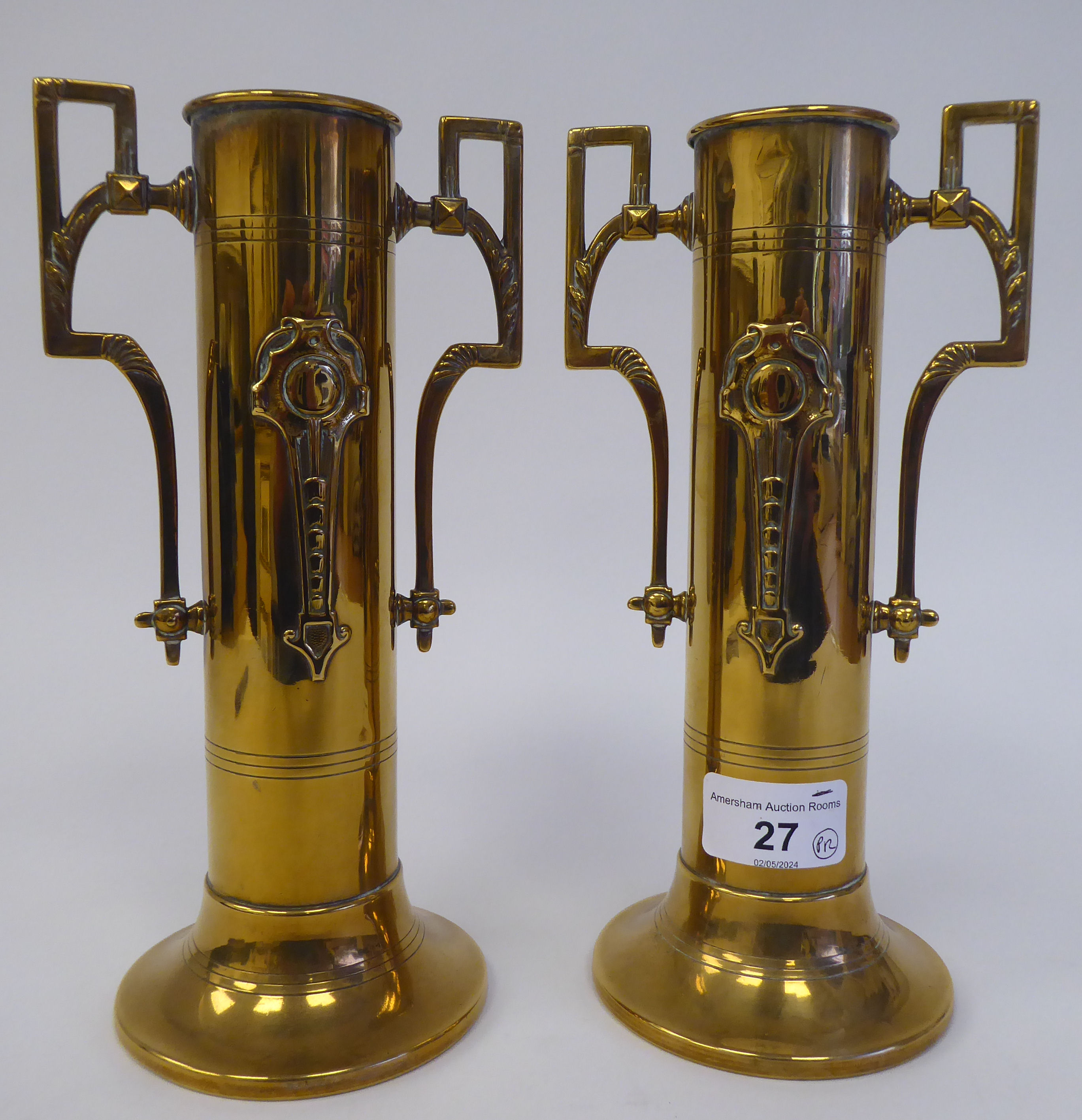 A pair of early 20thC Art Nouveau, Jugendstil style, brass cylindrical, twin handled spill vases