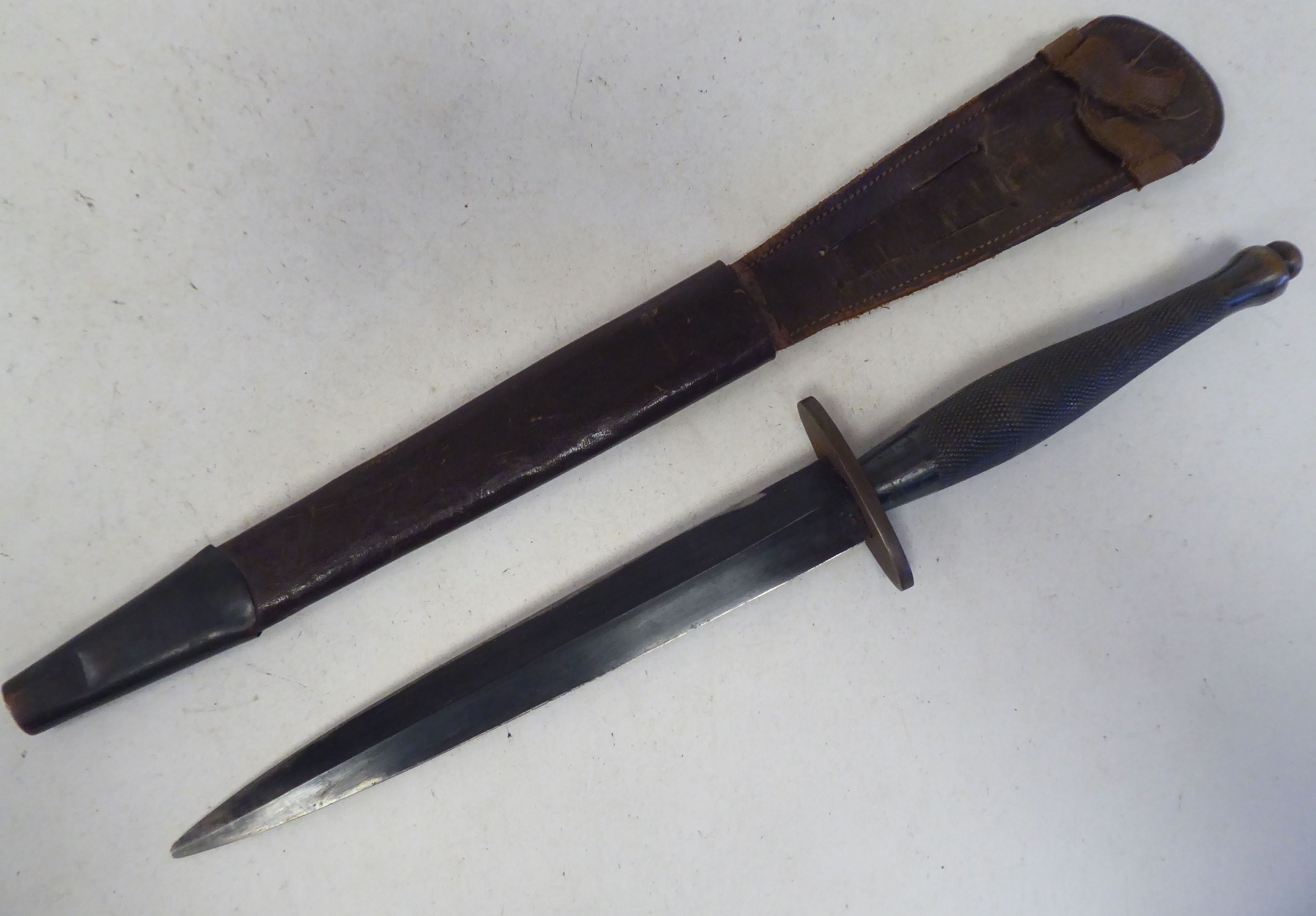 A World War II commando knife with a textured, elliptical handle, the blade 6.5"L in a moulded and