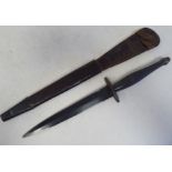 A World War II commando knife with a textured, elliptical handle, the blade 6.5"L in a moulded and