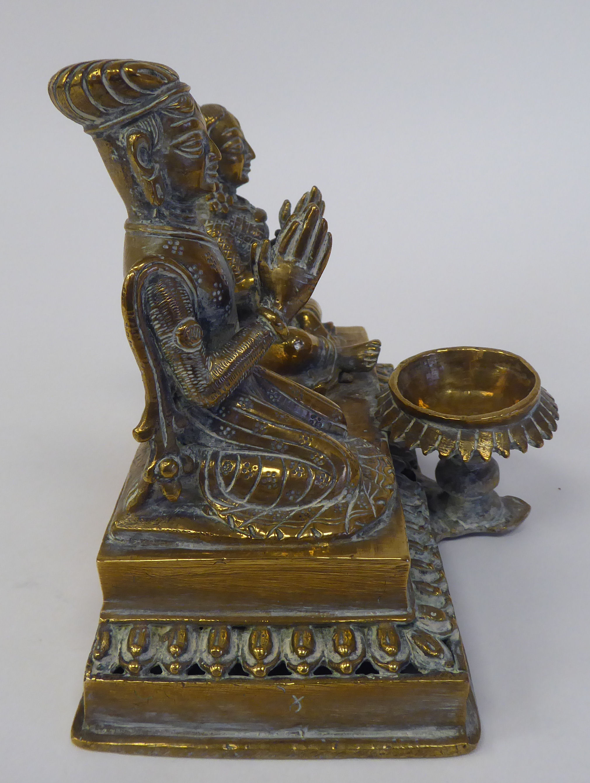 A pair of Asian brass religious deities, seated on a plinth between an outset pedestal vase  5"h - Image 4 of 4