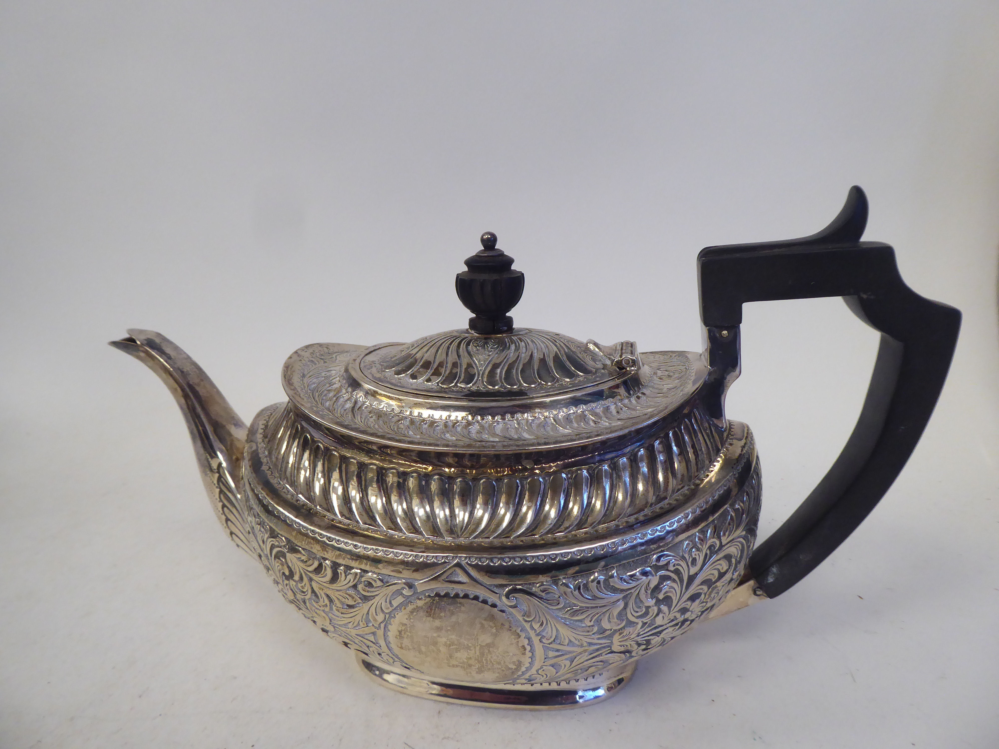 A late Victorian silver three piece tea set of oval form with engraved, chased and demi-reeded - Image 9 of 10