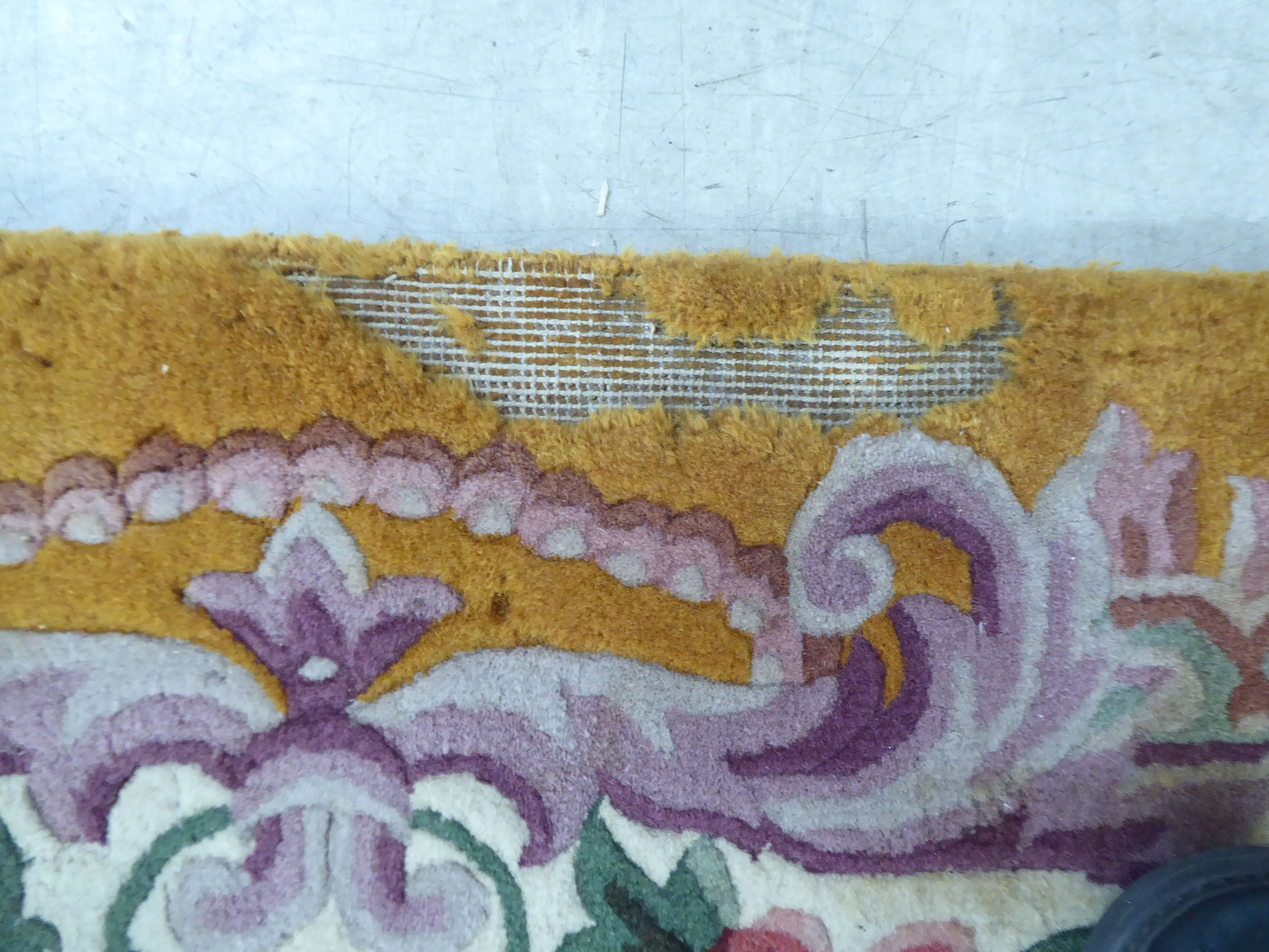 A traditional 20thC Chinese washed woollen carpet, decorated with flora, on a mustard coloured - Image 4 of 6