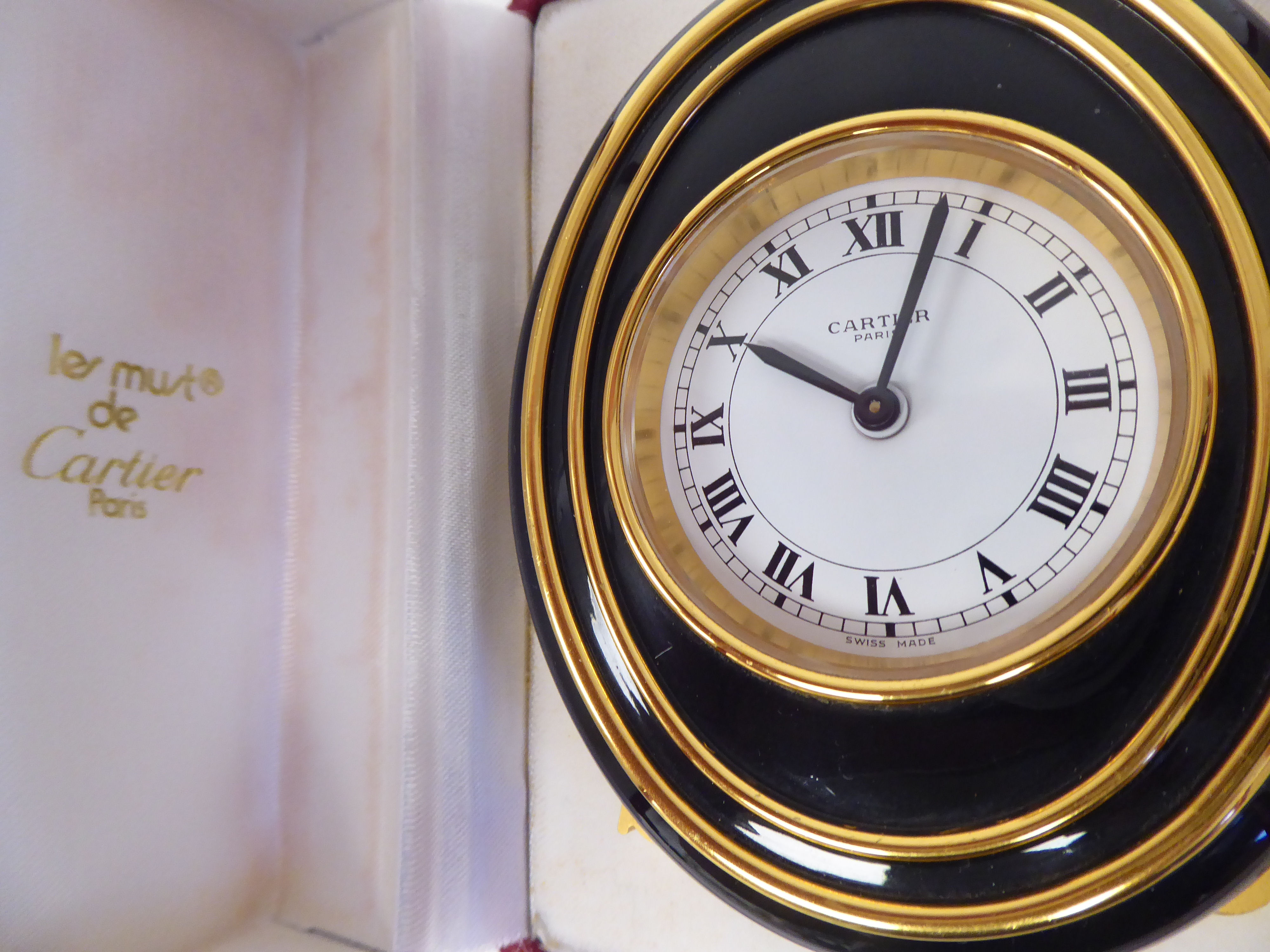 A Cartier travel clock, No.7511 00638, in a gilded and black enamel oval case, on an easel stand; - Image 2 of 6