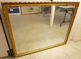 A modern mirror, the bevelled plate set in a moulded gilt frame  40" x 51"