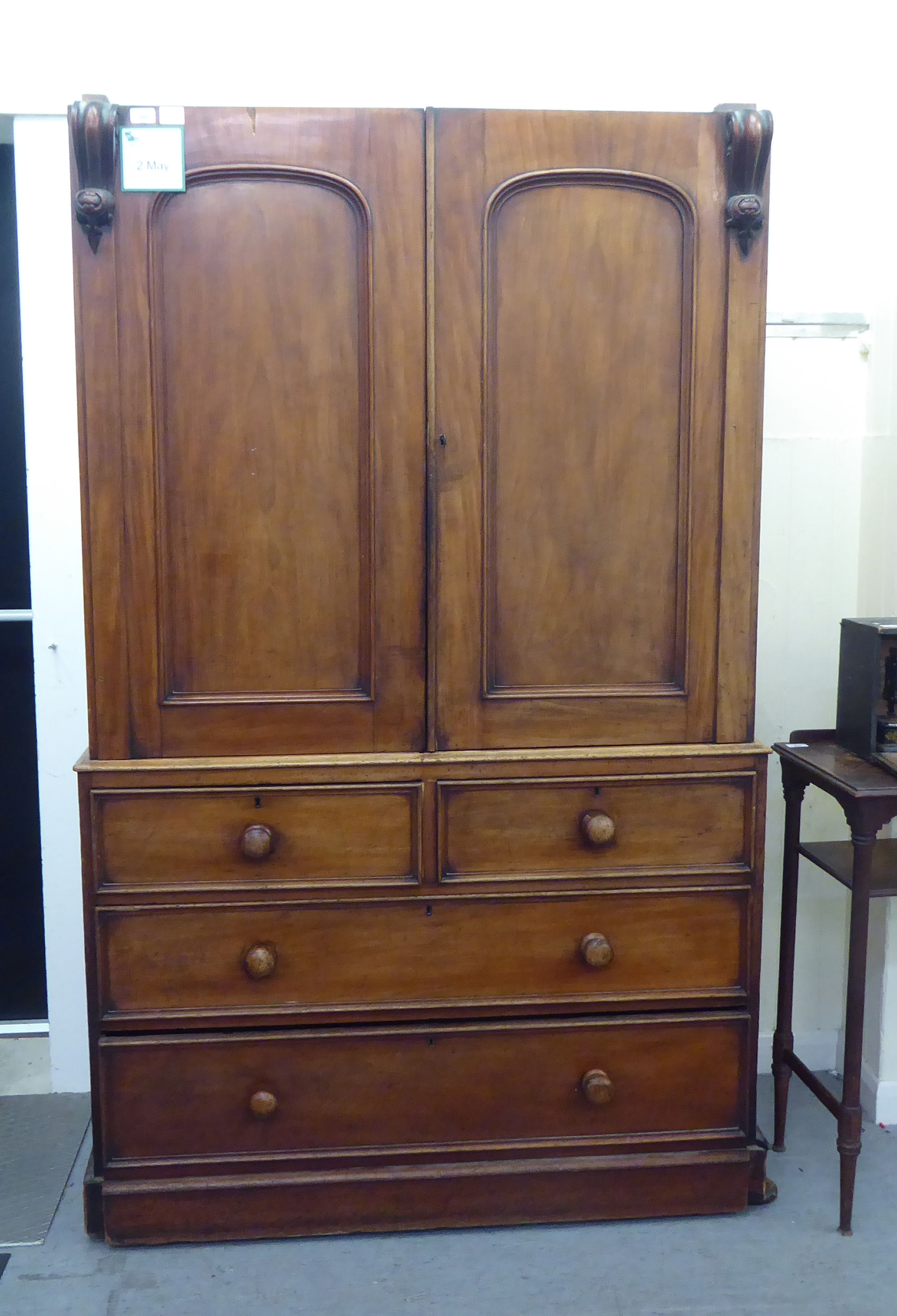 A mid Victorian mahogany linen press (cornice missing) with a pair of doors, enclosing four drawers,