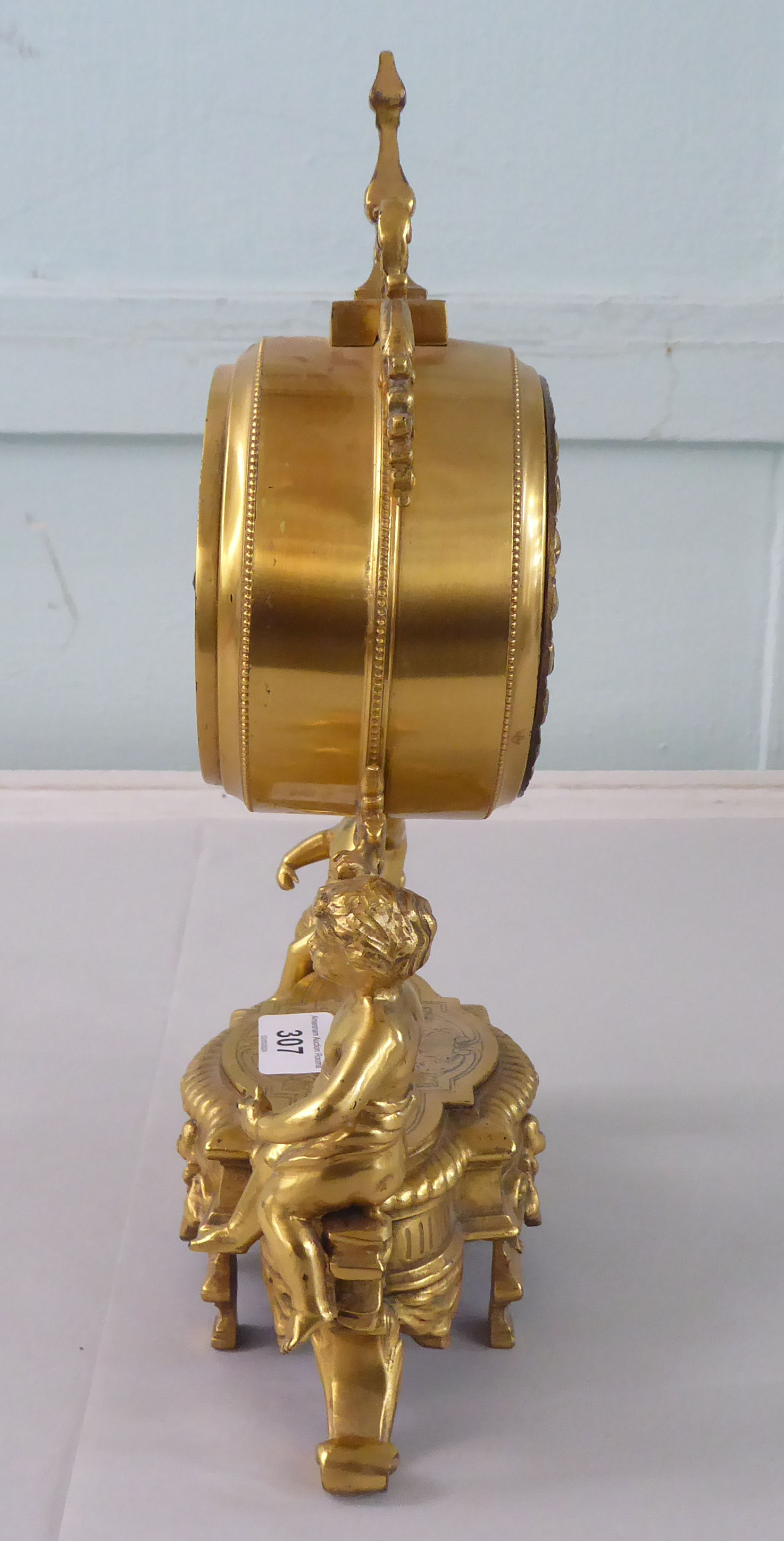 A mid 20thC Victorian design gilt metal mantel clock; the drum design movement faced by an enamelled - Image 3 of 7