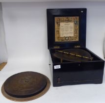 A late 19thC Brevete Patent black lacquered and gilded table-top Symphonion of box design with a