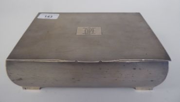 A silver cigarette box with allover engine turned decoration, the hinged lid enclosing a maple lined