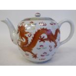 An early 20thC Chinese porcelain teapot of globular form with a swept spout, loop handle, cover
