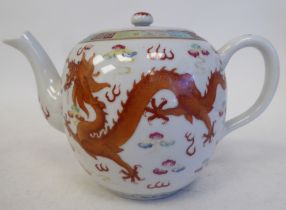 An early 20thC Chinese porcelain teapot of globular form with a swept spout, loop handle, cover