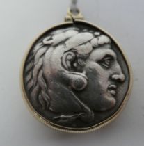 A silver coloured metal Alexander the Great coin, in a yellow metal, pendant ring mount