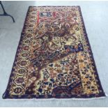 A Persian Bactiar style rug, decorated with free-flowing, stylised designs, on a multi-coloured