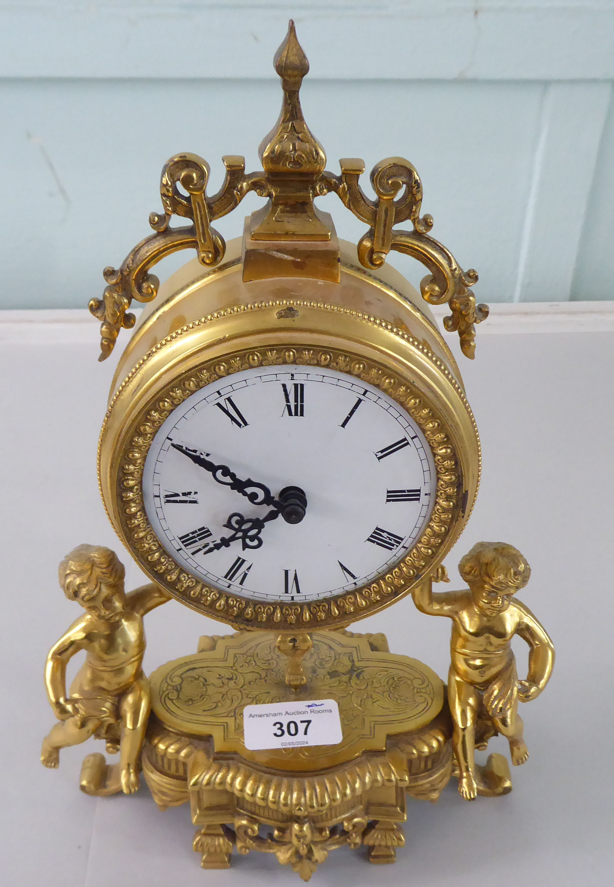 A mid 20thC Victorian design gilt metal mantel clock; the drum design movement faced by an enamelled - Image 2 of 7