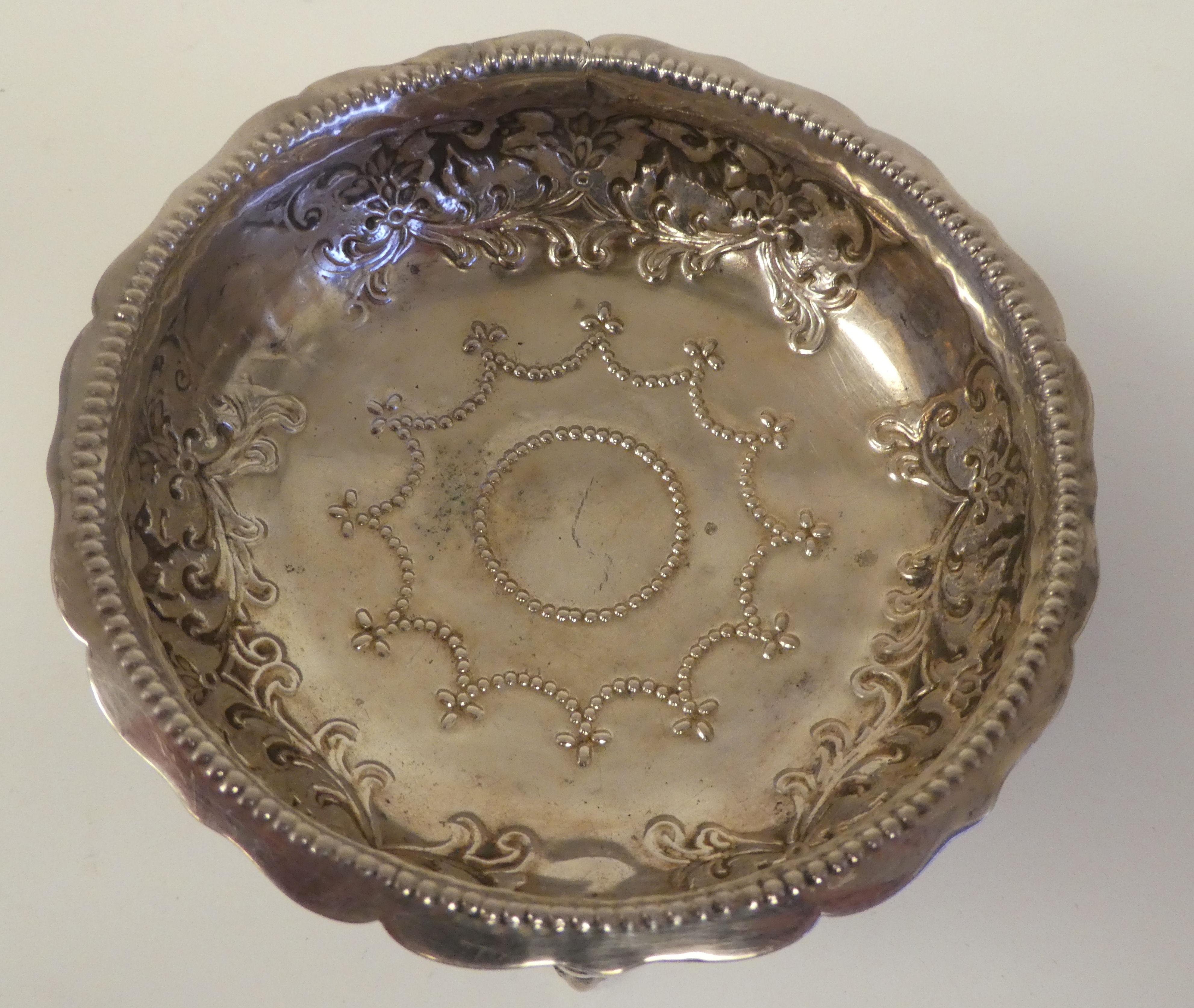 A late Victorian silver shallow bowl with a crimped rim, embossed foliage, flora and lion mask - Image 3 of 4