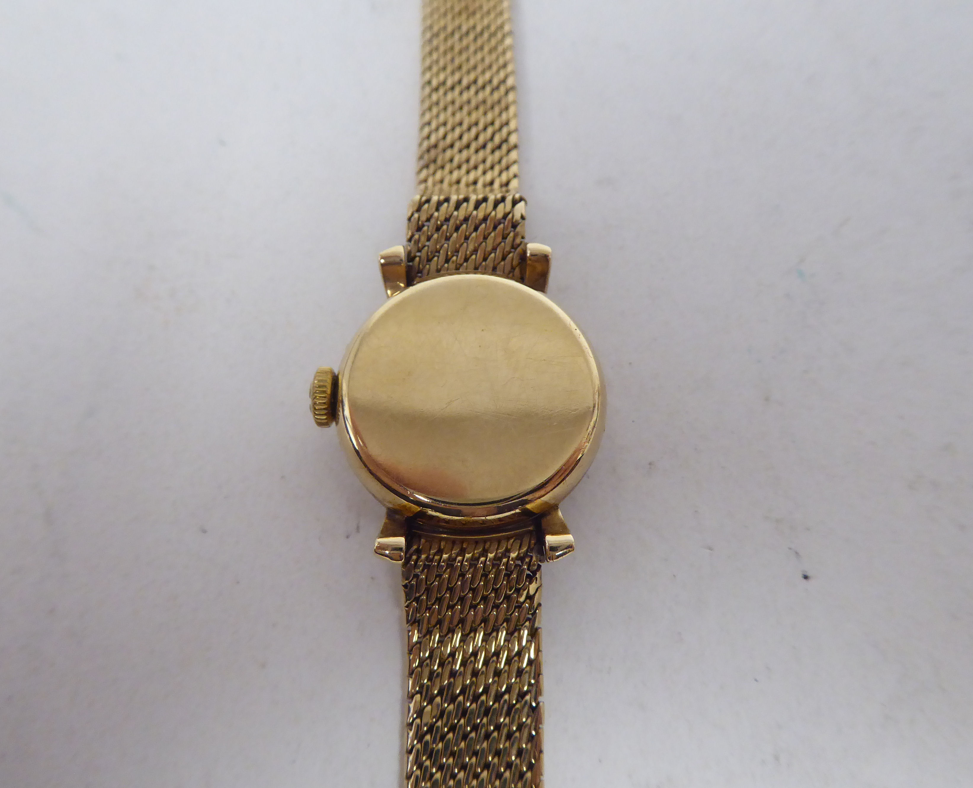 A lady's Omega 9ct round cased bracelet wristwatch, the manual wind mechanism faced by a baton dial - Bild 4 aus 7