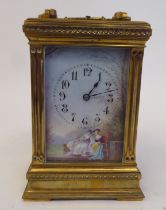 An early 20thC lacquered brass cased carriage clock with reeded corner pillars and scrolled friezes,