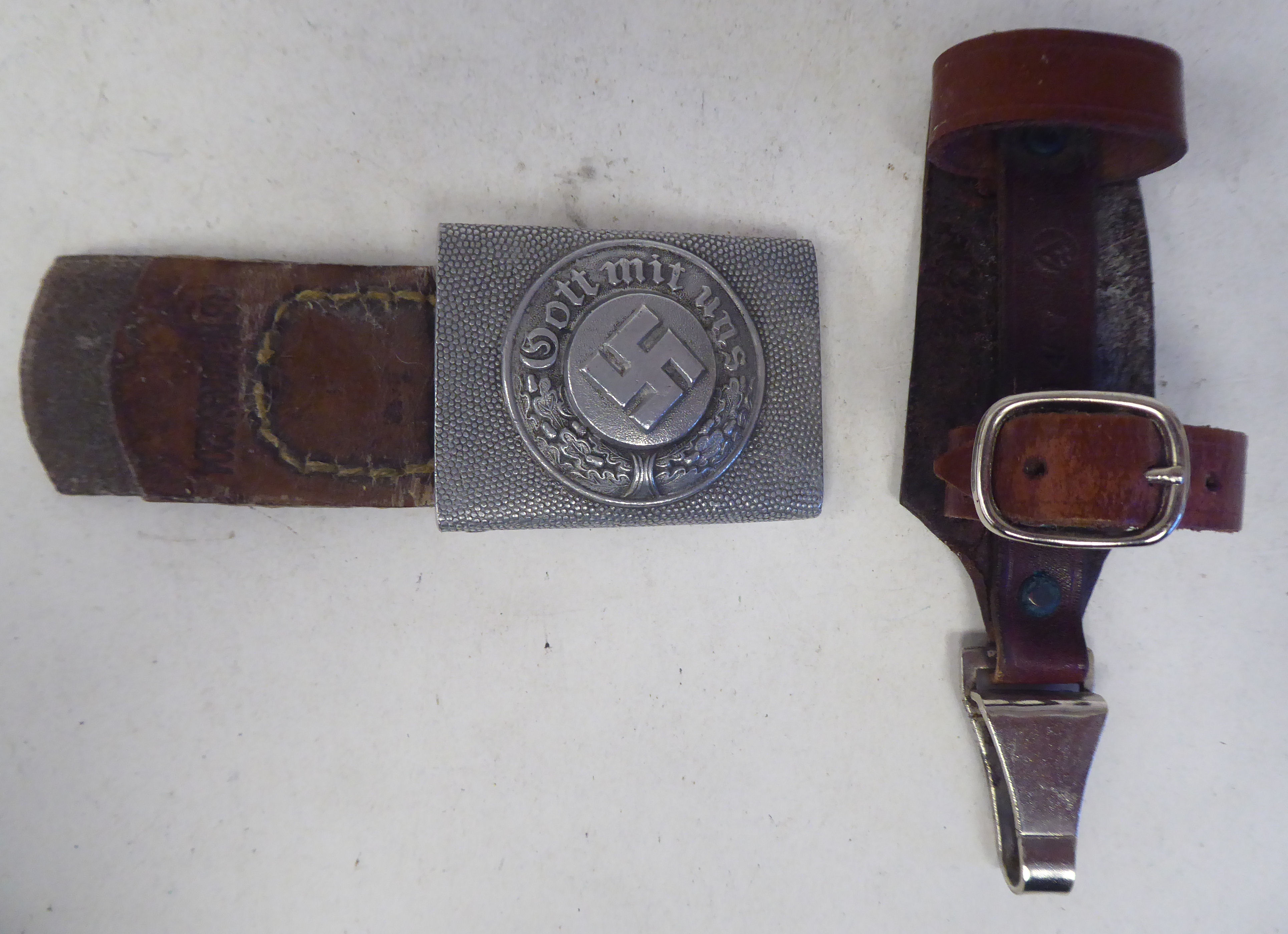 A German Third Reich era military belt buckle; and a buckled brown hide dagger strap (Please Note: