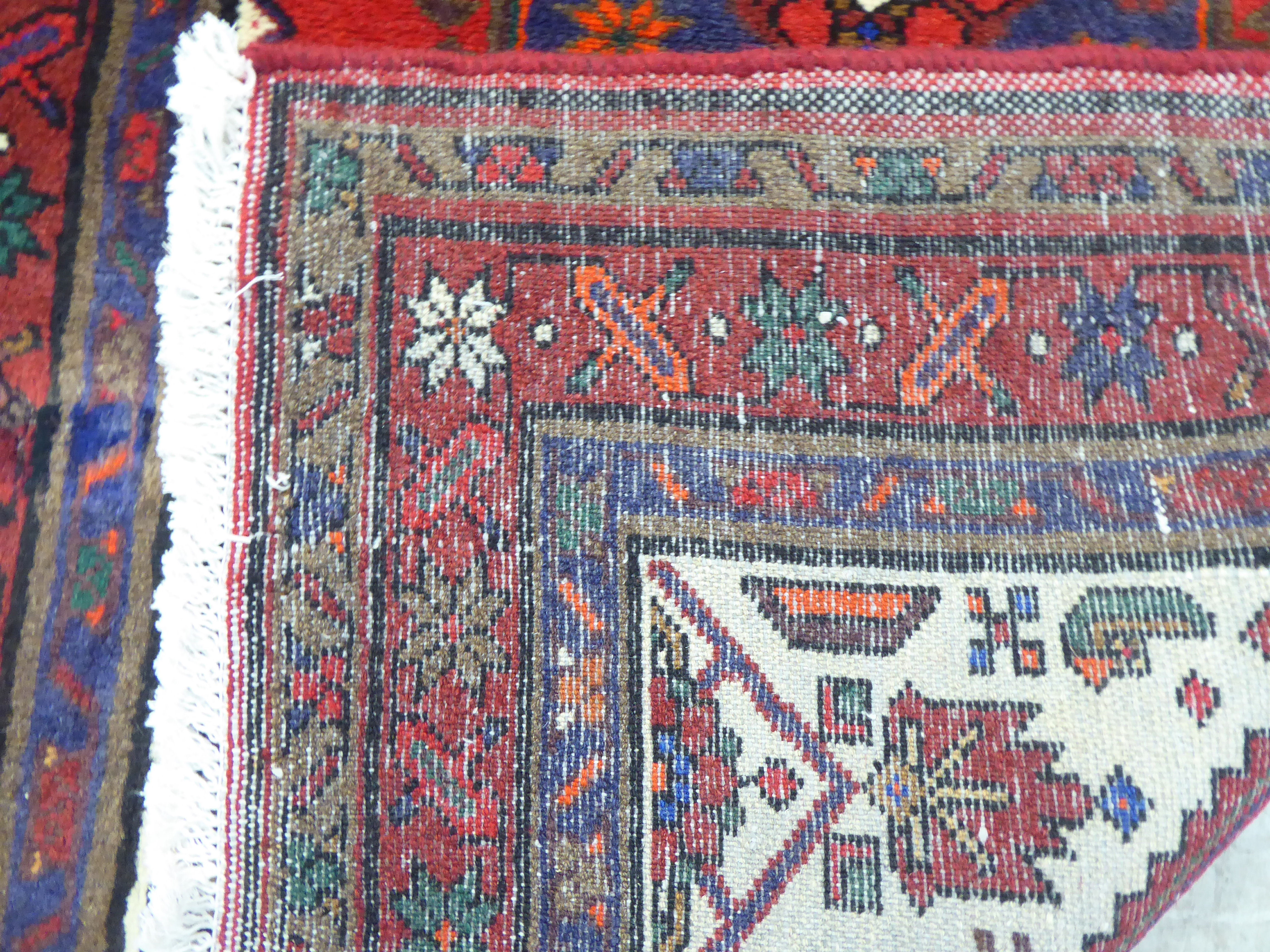 A Persian rug, on a red ground  37" x 59" - Image 4 of 4