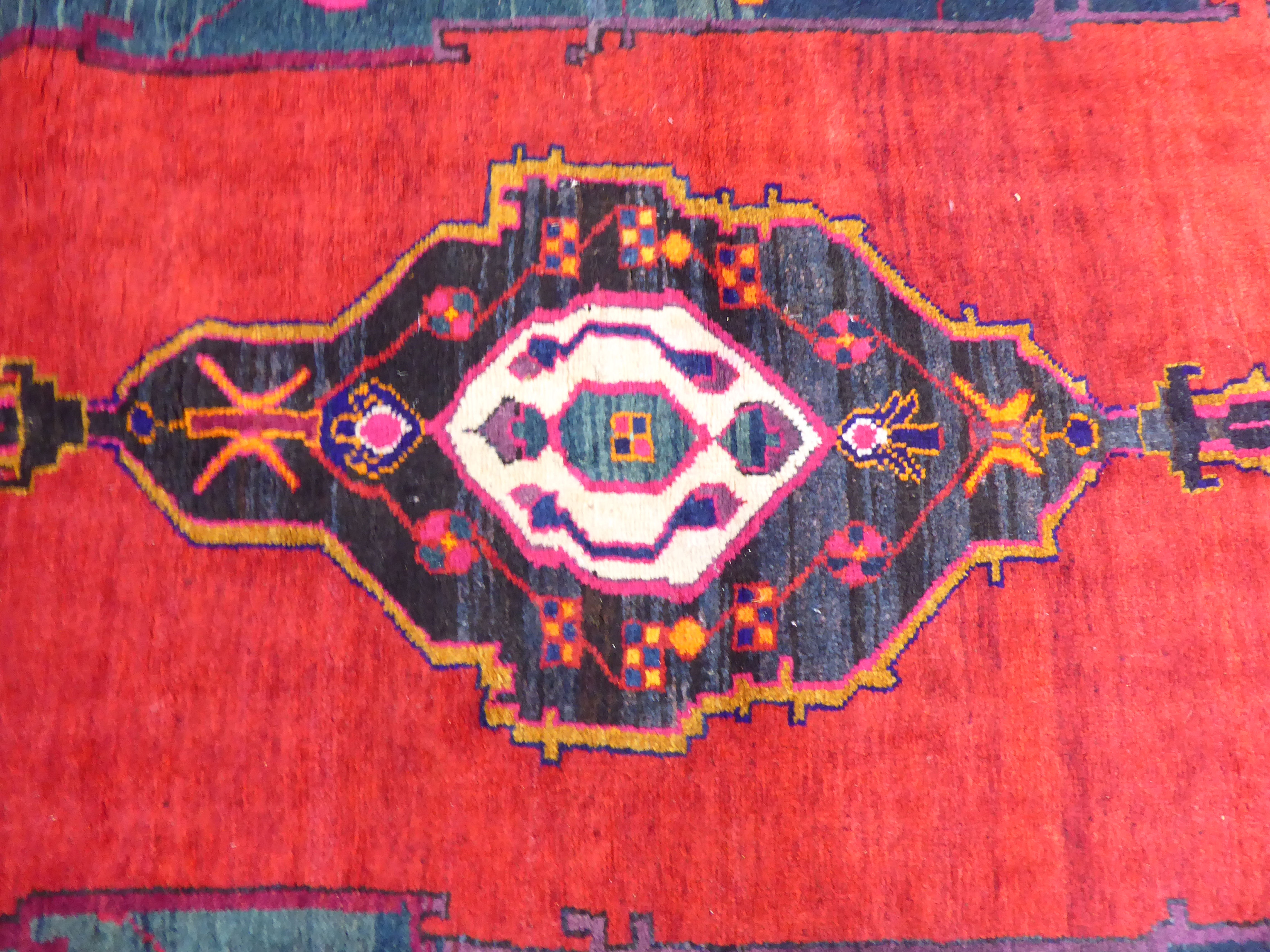 A Turkish rug with stylised designs, on a mainly red ground  52" x 88" - Image 2 of 4