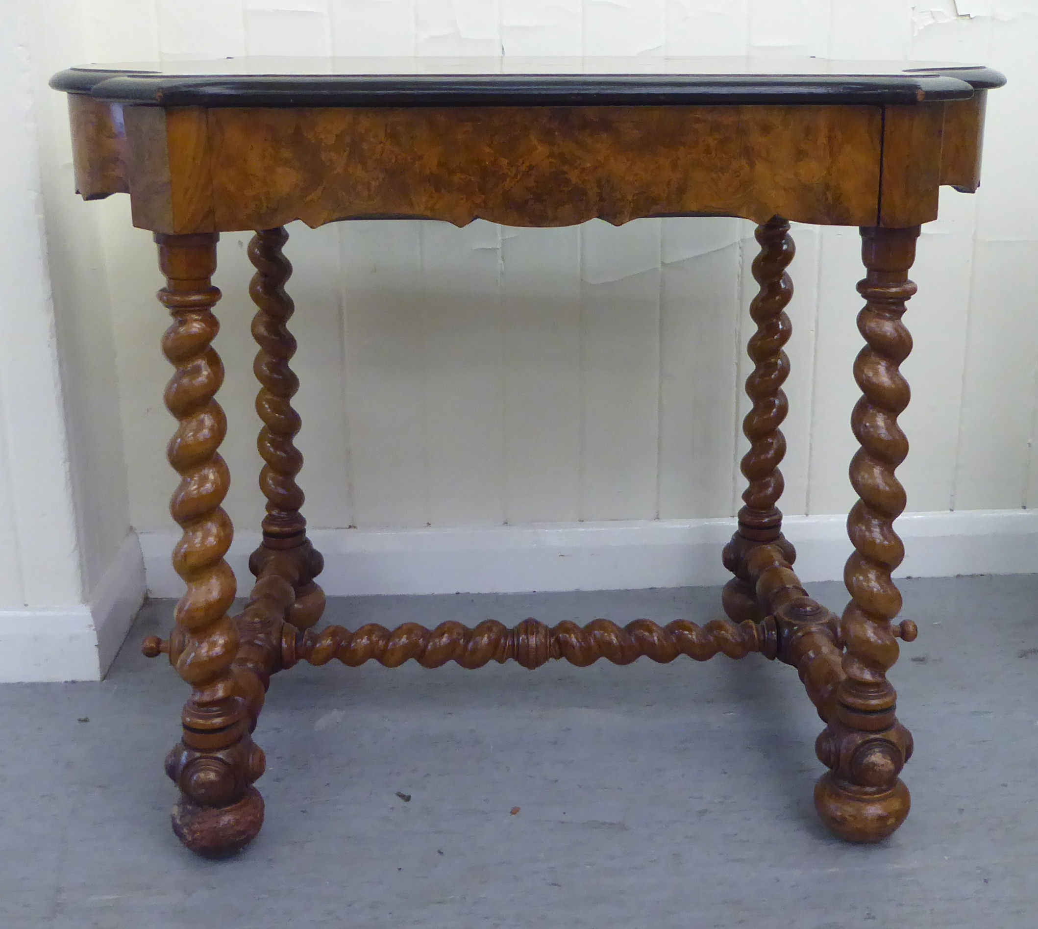 A late 19thC Continental figured walnut and floral marquetry games table with a serpentine