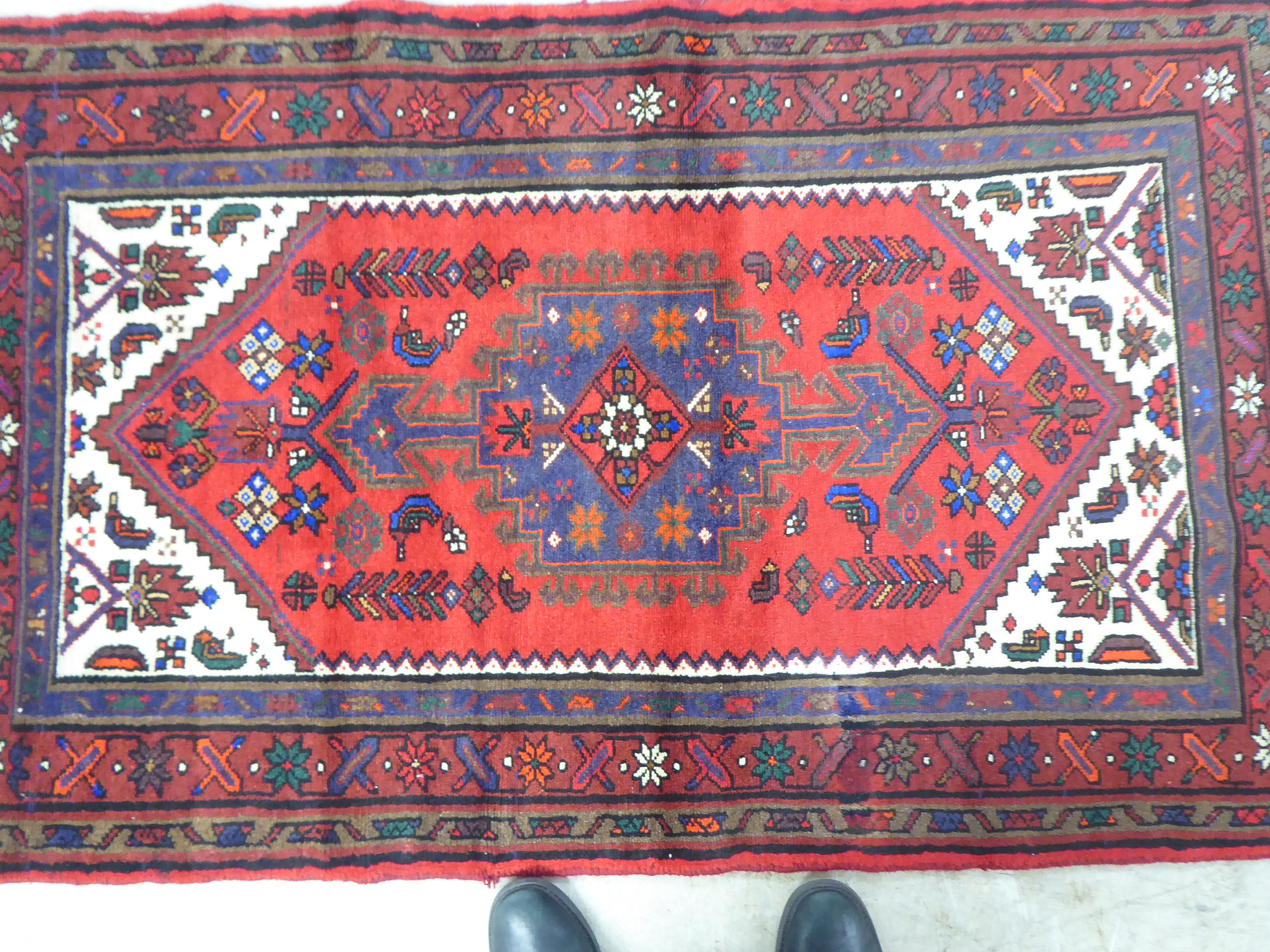 A Persian rug, on a red ground  37" x 59" - Image 2 of 4