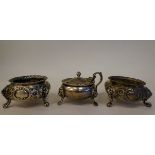 A pair of early Victorian silver shallow, bulbous salt cellars with embossed floral decoration,