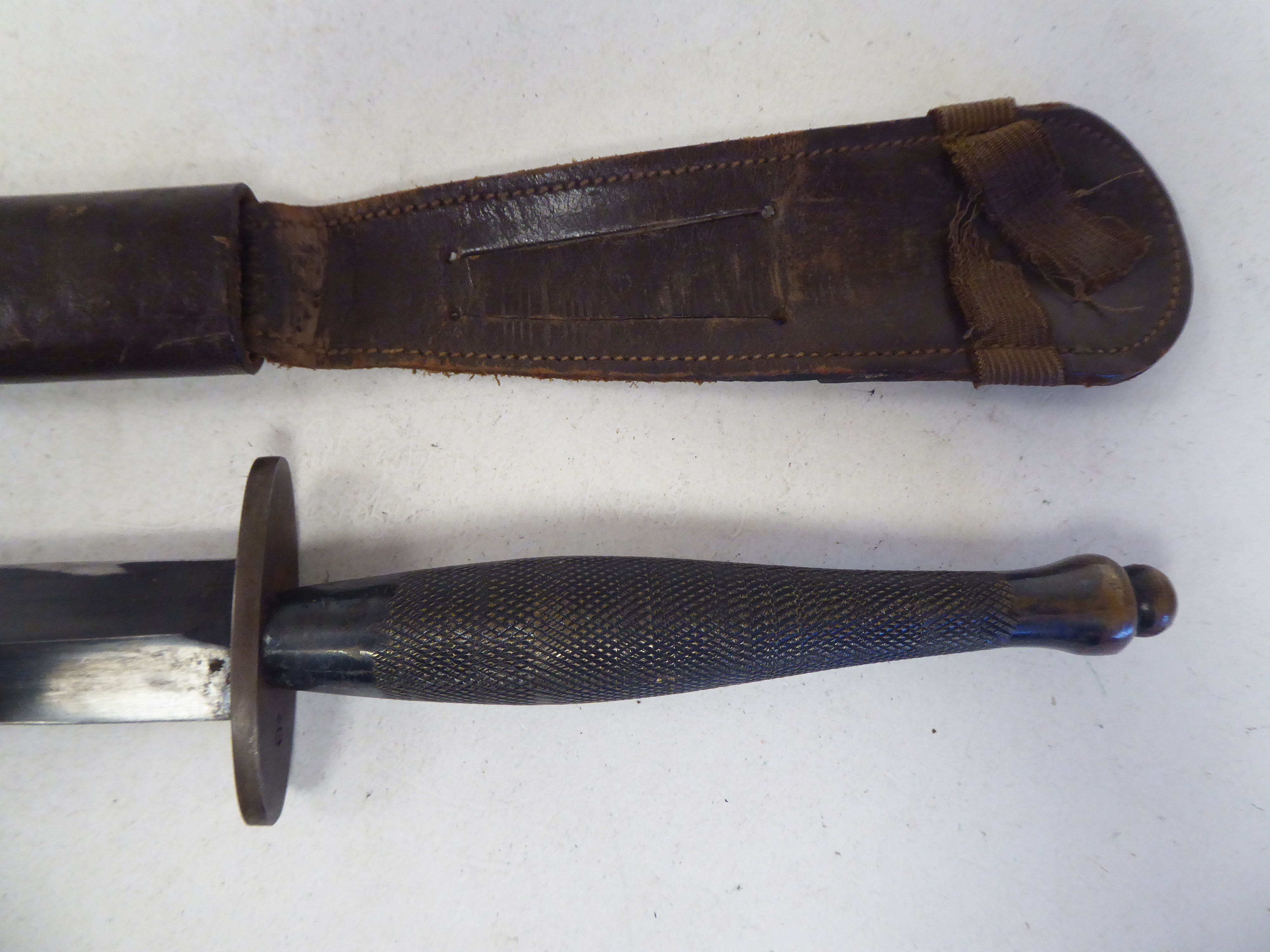 A World War II commando knife with a textured, elliptical handle, the blade 6.5"L in a moulded and - Image 2 of 4