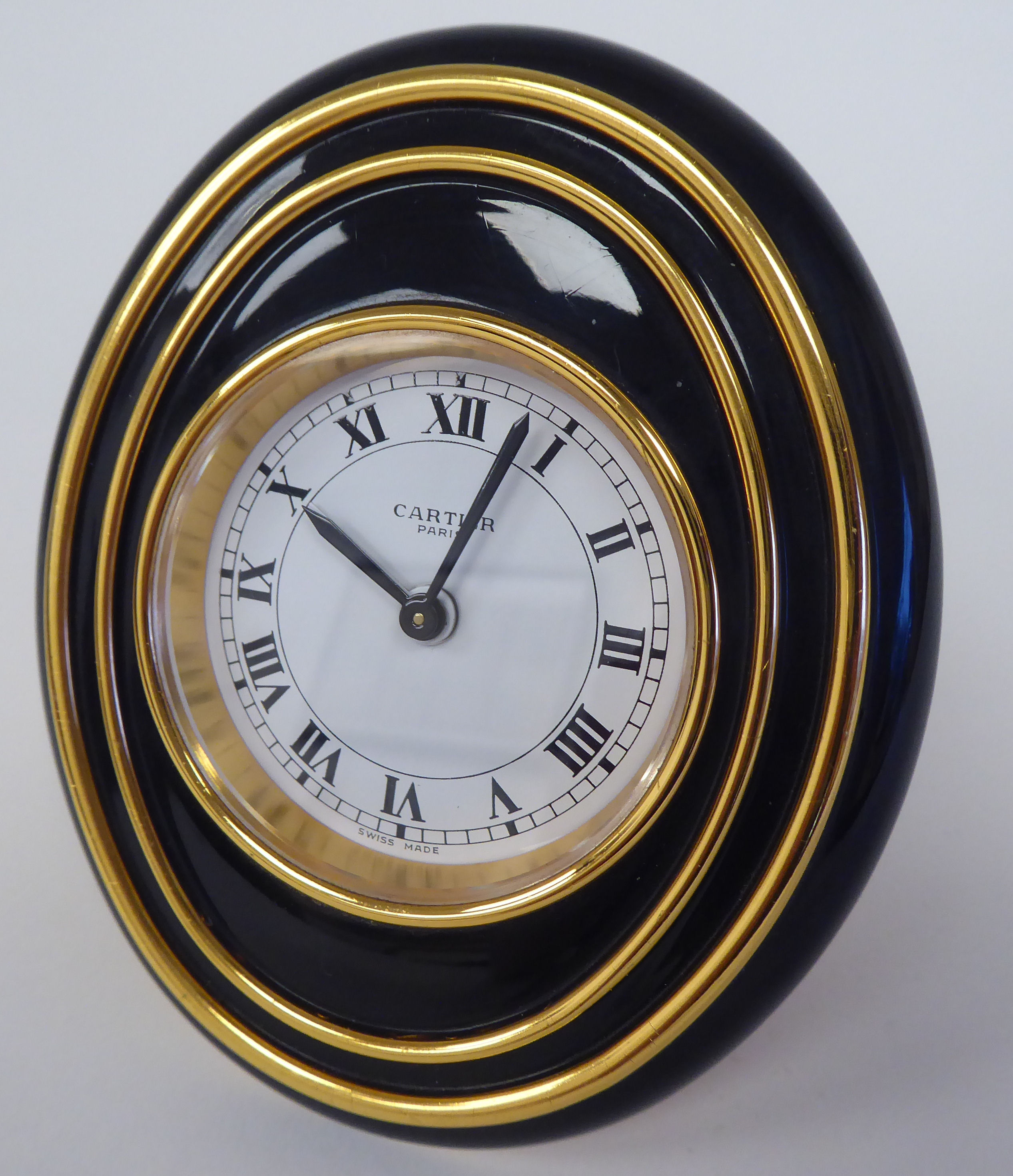 A Cartier travel clock, No.7511 00638, in a gilded and black enamel oval case, on an easel stand; - Image 3 of 6