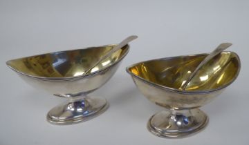 A pair of George IV silver and parcel gilt, oval salt cellars with applied wire rims; and a pair