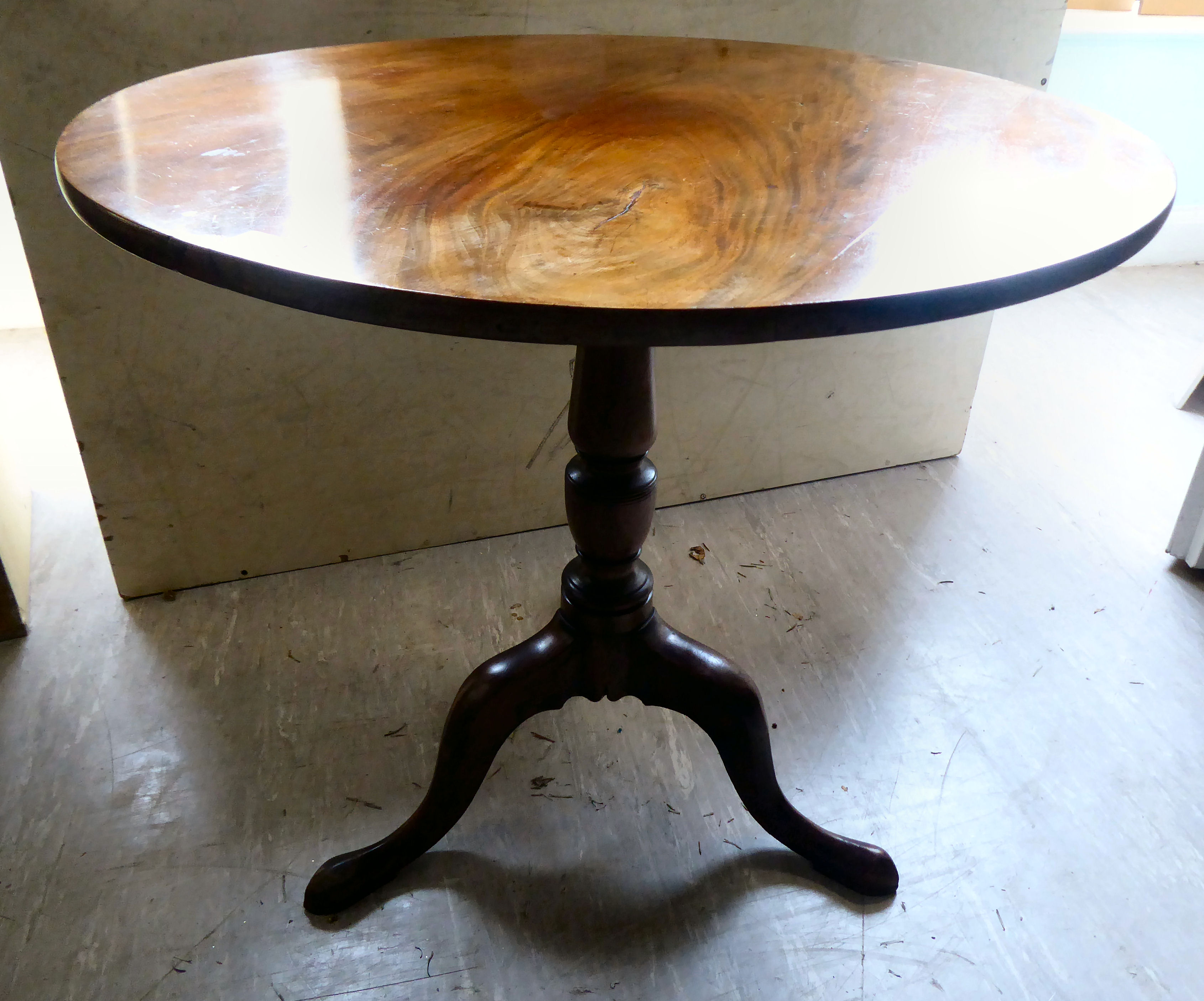 A George III mahogany pedestal table, the tip-top raised on a tripod base and pad feet  28"h  30"dia