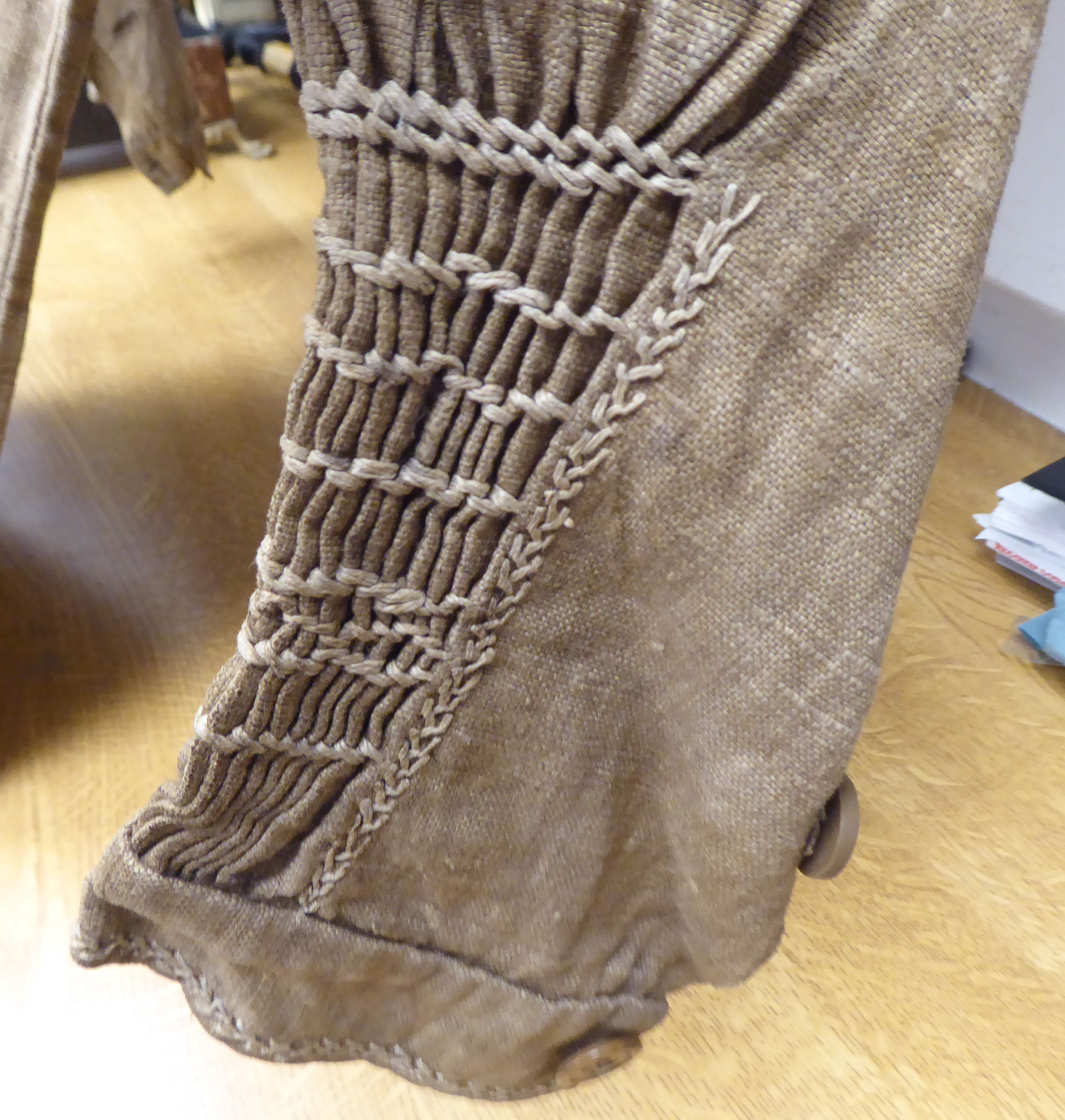 A Continental artisan's brown calico pleated dress with decorative, stone coloured embroidery and - Image 3 of 3