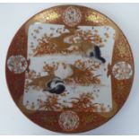 A late 19thC Japanese Kutani style porcelain charger, decorated in with vignette studies of birds,