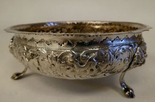 A late Victorian silver shallow bowl with a crimped rim, embossed foliage, flora and lion mask
