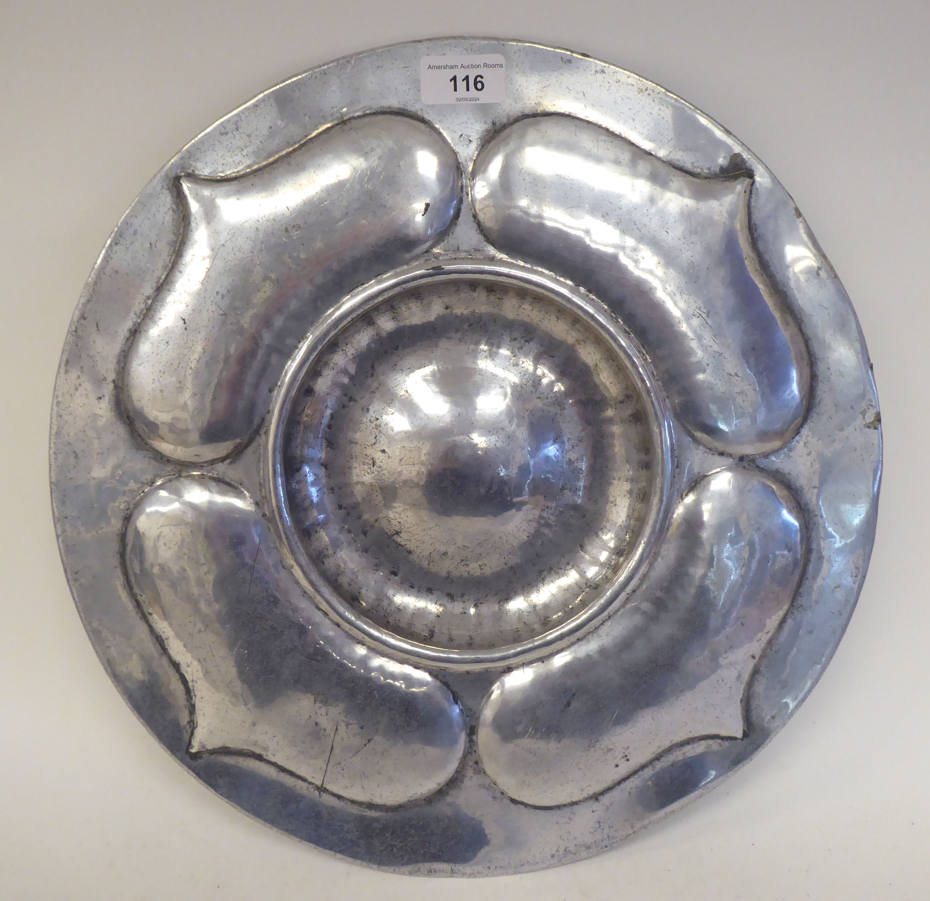 A Pewtal dish with a depressed centre, the wide rim ornamented in Art Nouveau inspired designs  15"