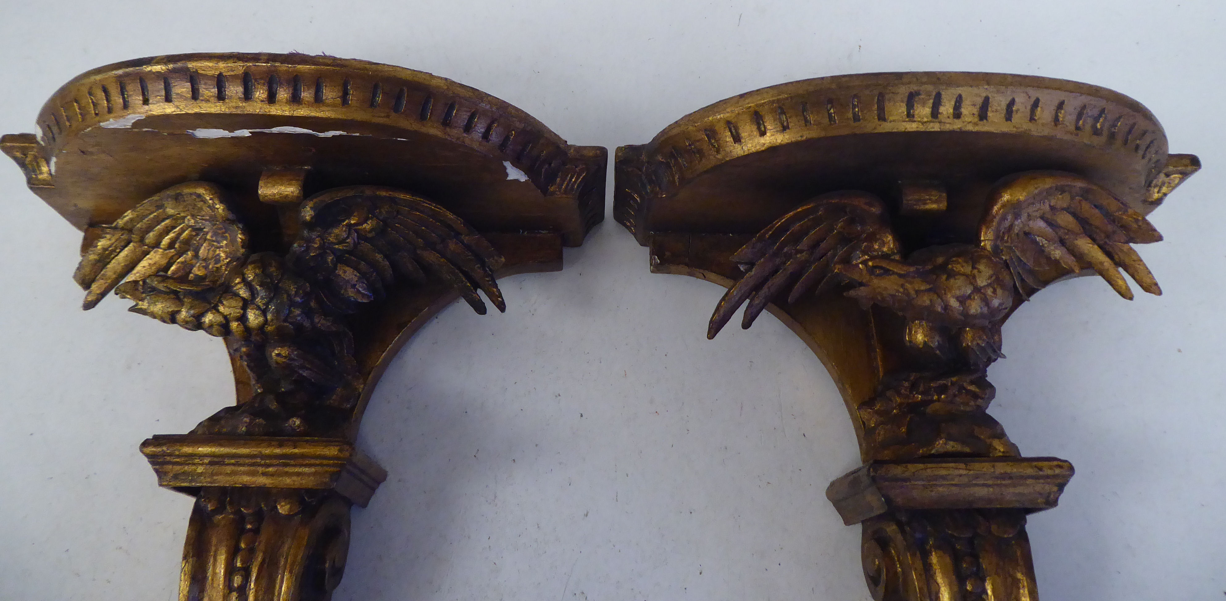 A pair of late 19thC carved wooden and gilt gesso moulded wall brackets, each featuring a semi- - Image 2 of 2