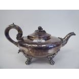 An early 19thC silver teapot of squat, bulbous form with swept spout, a hinged lid, fruit finial and