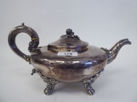 An early 19thC silver teapot of squat, bulbous form with swept spout, a hinged lid, fruit finial and